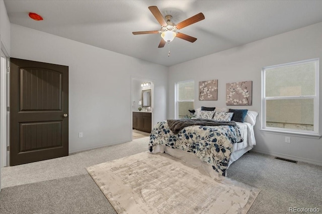 carpeted bedroom with ceiling fan and ensuite bathroom