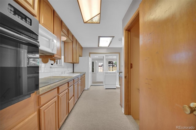 8841 Hunter Way, Westminster, CO 80031 - kitchen featuring white appliances, light colored carpet, tasteful backsplash, independent washer and dryer, and light countertops
