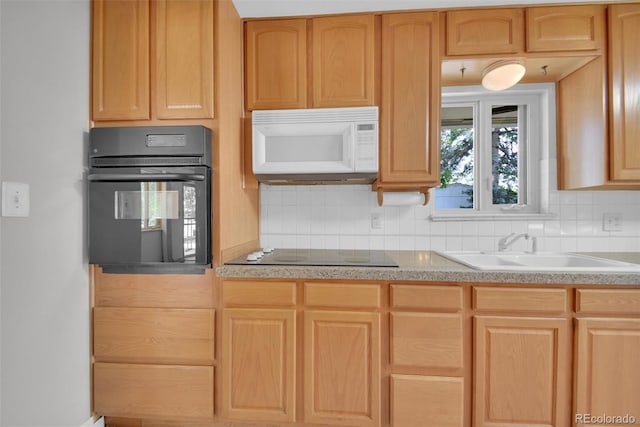 8841 Hunter Way, Westminster, CO 80031 - kitchen featuring black appliances, light brown cabinets, backsplash, and light countertops
