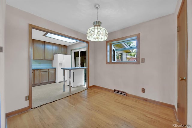 8841 Hunter Way, Westminster, CO 80031 - unfurnished dining area with a chandelier and light wood finished floors