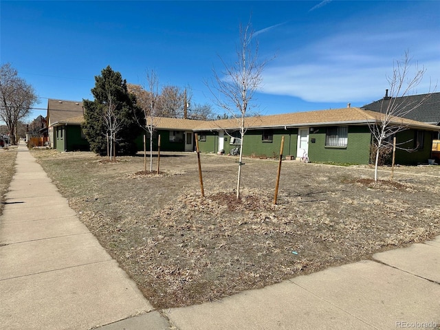 ranch-style house featuring brick siding