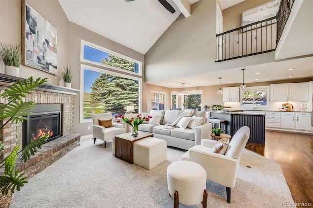 7067 Gray Fox Ct, Highlands Ranch, CO 80130 - living area with high vaulted ceiling, a fireplace, recessed lighting, light wood-type flooring, and baseboards