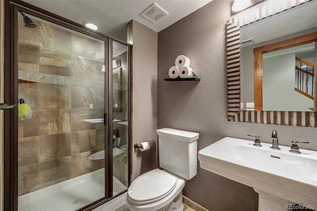 7067 Gray Fox Ct, Highlands Ranch, CO 80130 - full bath featuring toilet, a shower stall, a textured wall, and a sink