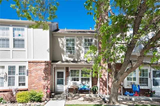 9713 W Chatfield Ave Unit F, Littleton, CO 80128 - view of property with brick siding and stucco siding