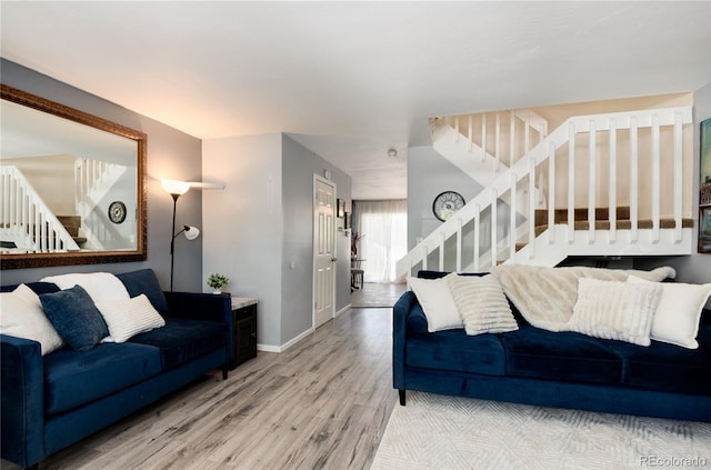 9713 W Chatfield Ave Unit F, Littleton, CO 80128 - living room with stairway, wood finished floors, and baseboards
