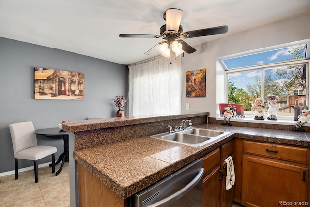 9713 W Chatfield Ave Unit F, Littleton, CO 80128 - kitchen with dishwasher, a sink, tile counters, a peninsula, and brown cabinets