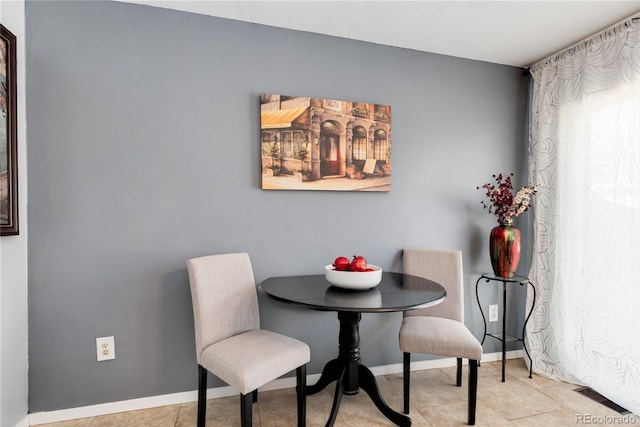 9713 W Chatfield Ave Unit F, Littleton, CO 80128 - dining area featuring baseboards and light tile patterned floors