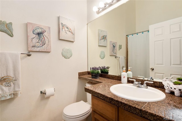 9713 W Chatfield Ave Unit F, Littleton, CO 80128 - bathroom featuring vanity, toilet, and curtained shower