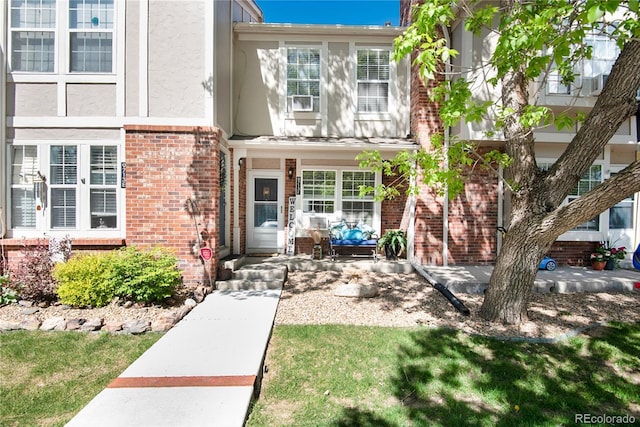 9713 W Chatfield Ave Unit F, Littleton, CO 80128 - property entrance with brick siding and stucco siding