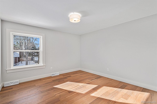 empty room with hardwood / wood-style flooring