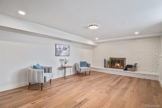 sitting room featuring hardwood / wood-style flooring and a fireplace