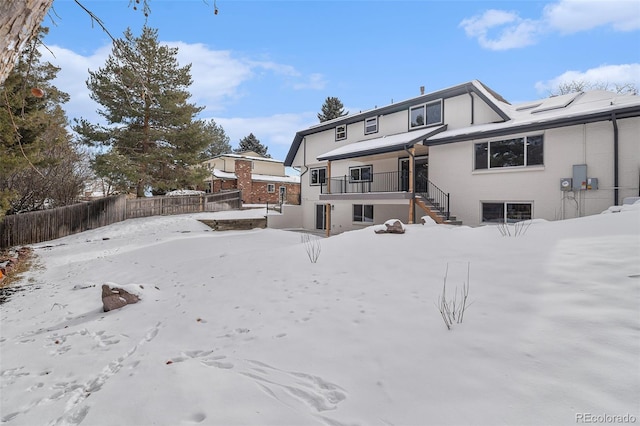 view of snow covered rear of property