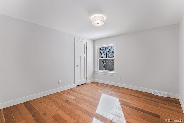 empty room with light hardwood / wood-style flooring