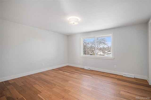 unfurnished room featuring hardwood / wood-style floors