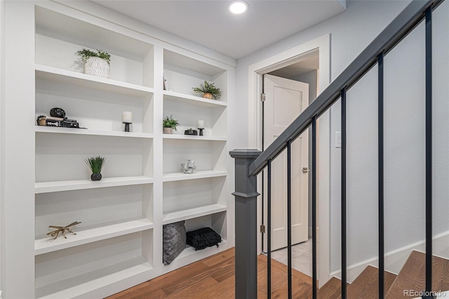 stairs featuring hardwood / wood-style floors