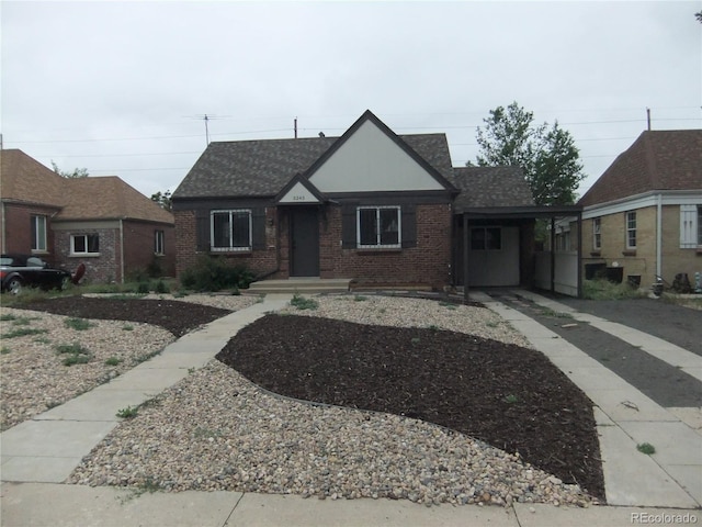 3243 Albion St, Denver, CO 80207 - tudor home featuring brick siding and a shingled roof