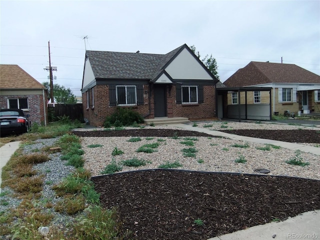 3243 Albion St, Denver, CO 80207 - tudor home featuring brick siding and roof with shingles