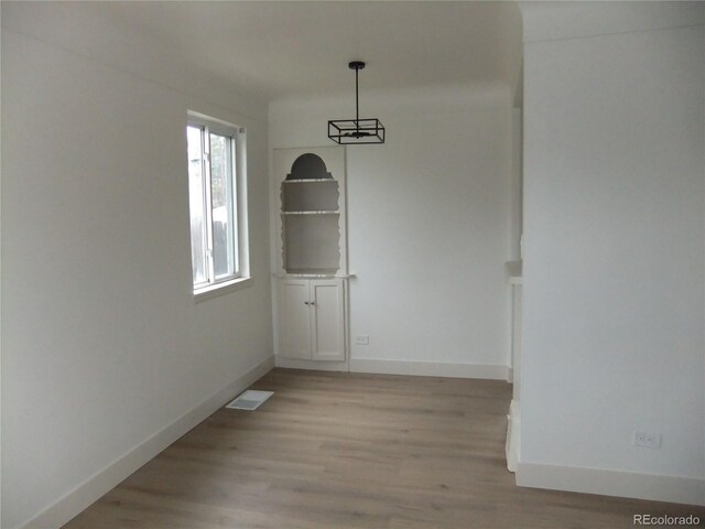 3243 Albion St, Denver, CO 80207 - unfurnished dining area with light wood-style flooring and baseboards