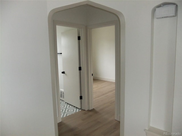 3243 Albion St, Denver, CO 80207 - hall featuring wood finished floors and arched walkways