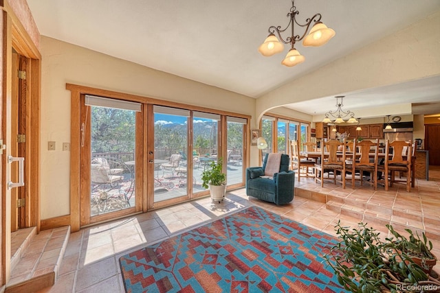 tiled living room with a chandelier and lofted ceiling