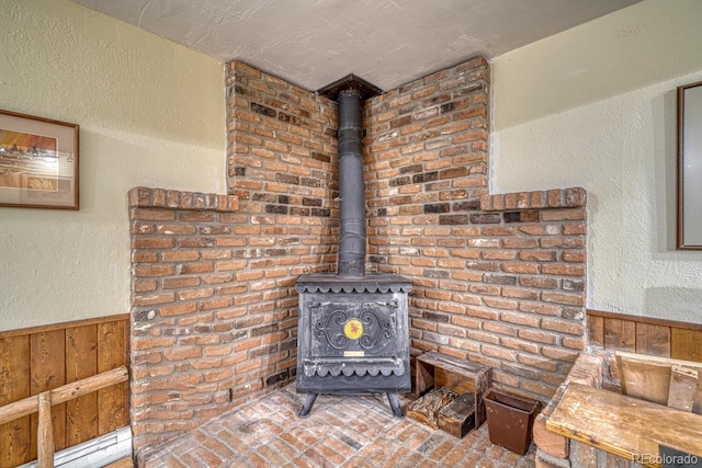 room details featuring a wood stove and wooden walls