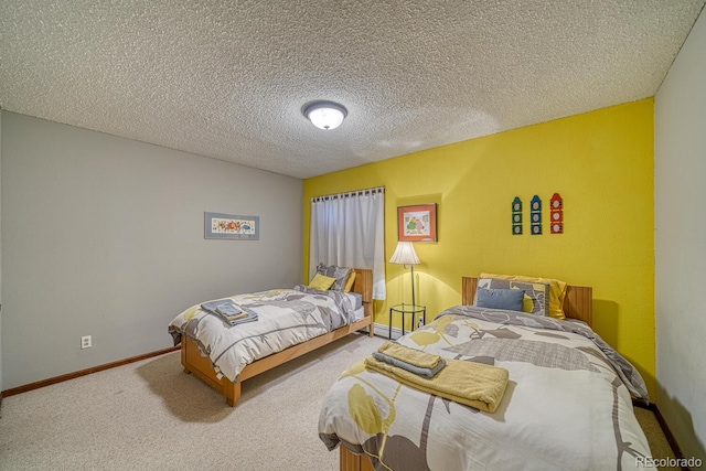 carpeted bedroom with baseboard heating and a textured ceiling