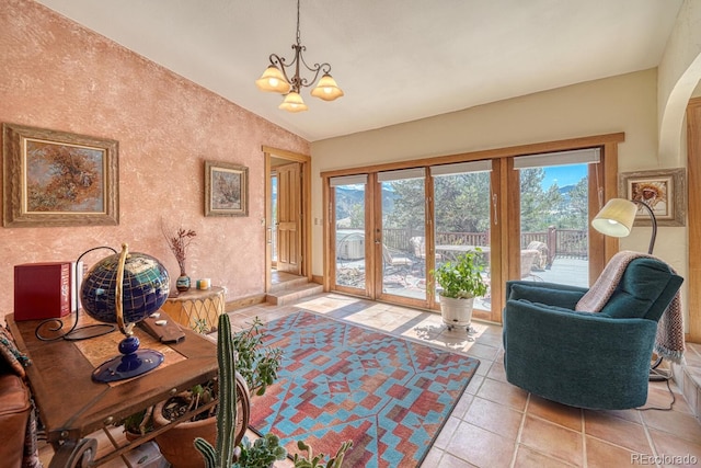 interior space with a chandelier, french doors, and vaulted ceiling