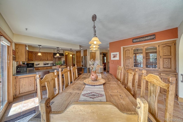 dining space with a textured ceiling and a wealth of natural light