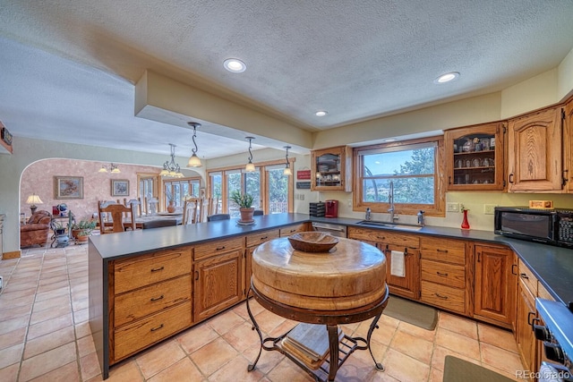 kitchen with a textured ceiling, sink, and a wealth of natural light