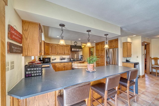 kitchen featuring stainless steel fridge with ice dispenser, range hood, a textured ceiling, decorative light fixtures, and light tile patterned floors