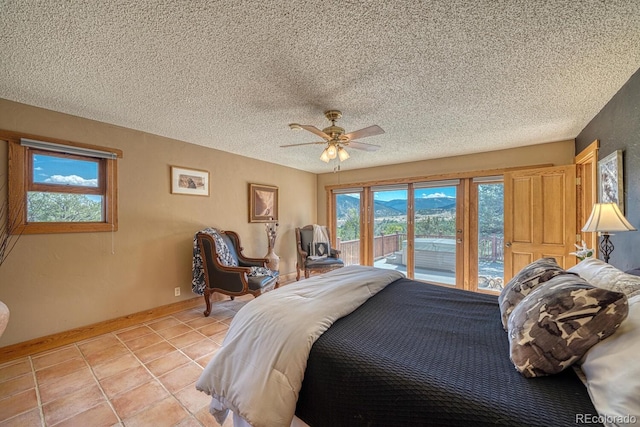 tiled bedroom with ceiling fan, a textured ceiling, and access to outside