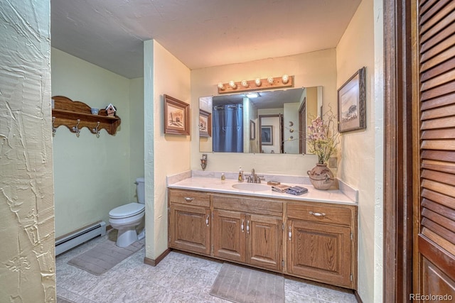 bathroom with tile patterned floors, vanity, toilet, and a baseboard radiator