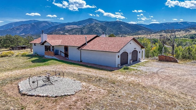 exterior space with a mountain view and a garage