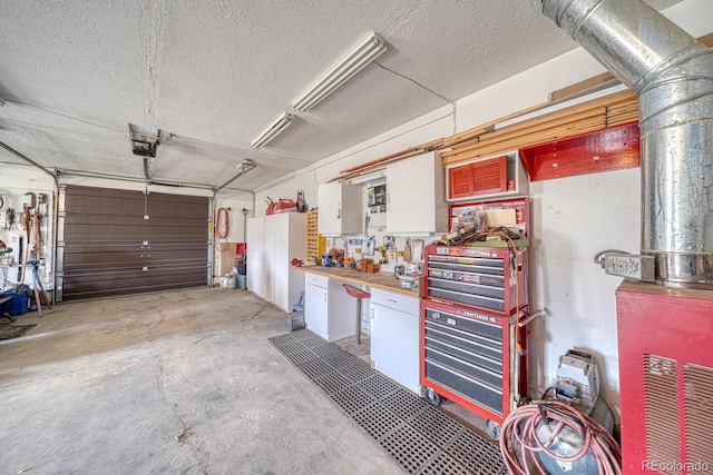 garage featuring a workshop area and a garage door opener