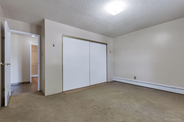 13606 E Bates Ave Unit 102, Aurora, CO 80014 - unfurnished bedroom with a textured ceiling, carpet, a baseboard heating unit, and a closet