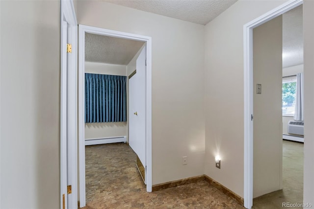 13606 E Bates Ave Unit 102, Aurora, CO 80014 - hallway with a baseboard heating unit and a textured ceiling