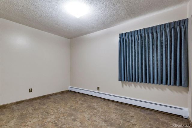 13606 E Bates Ave Unit 102, Aurora, CO 80014 - spare room featuring a baseboard radiator and a textured ceiling
