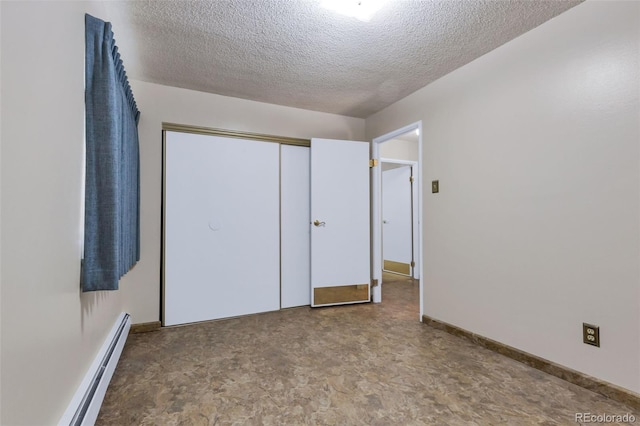 13606 E Bates Ave Unit 102, Aurora, CO 80014 - unfurnished bedroom featuring baseboard heating, a textured ceiling, and a closet