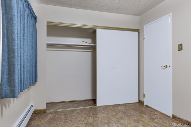 13606 E Bates Ave Unit 102, Aurora, CO 80014 - unfurnished bedroom with a baseboard heating unit, a closet, and a textured ceiling