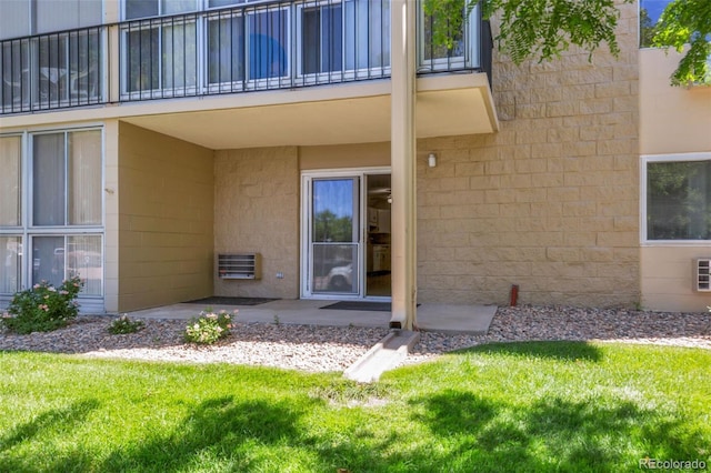 13606 E Bates Ave Unit 102, Aurora, CO 80014 - entrance to property with a patio area, heating unit, a balcony, and a lawn