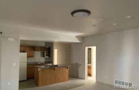 kitchen with white fridge and a kitchen island