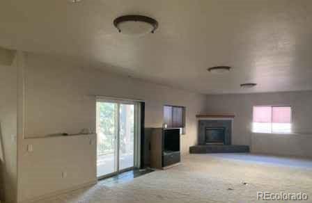 unfurnished living room featuring light carpet