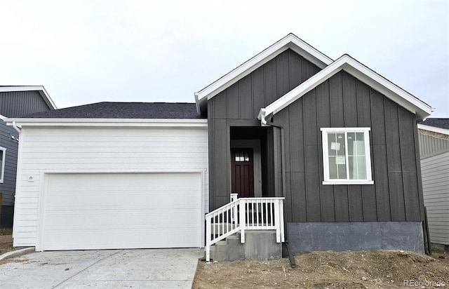 view of front of property with concrete driveway, a garage, and board and batten siding