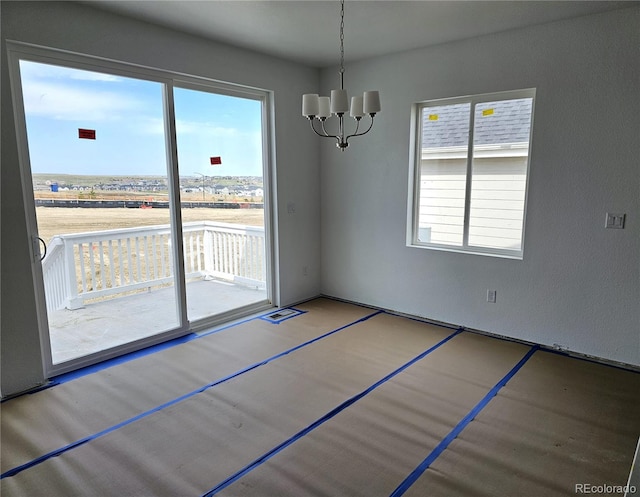 unfurnished dining area with a notable chandelier