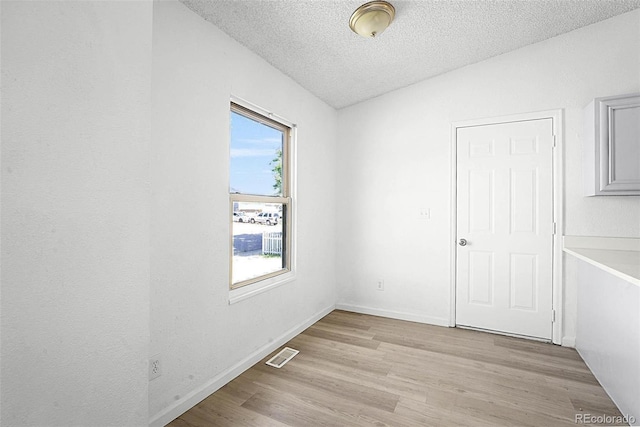 5112 Duluth Ct, Denver, CO 80239 - spare room with light wood-style flooring and a textured ceiling