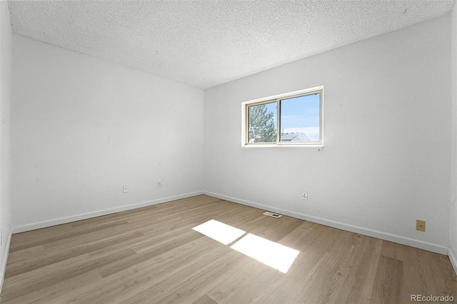 5112 Duluth Ct, Denver, CO 80239 - empty room with light wood-style flooring and a textured ceiling