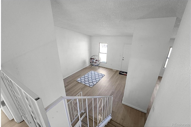 5112 Duluth Ct, Denver, CO 80239 - stairs with a textured ceiling and wood finished floors
