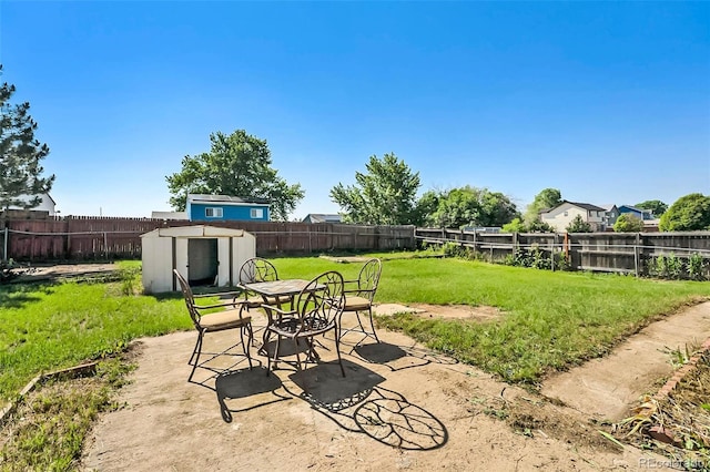 5112 Duluth Ct, Denver, CO 80239 - fenced backyard with a shed, outdoor dining area, and a patio area