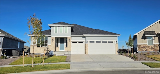 view of front of property featuring a front yard, cooling unit, and a garage