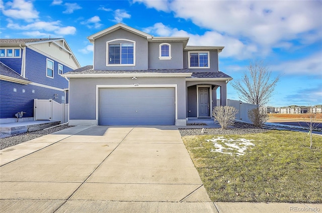 view of property featuring a garage and a front yard